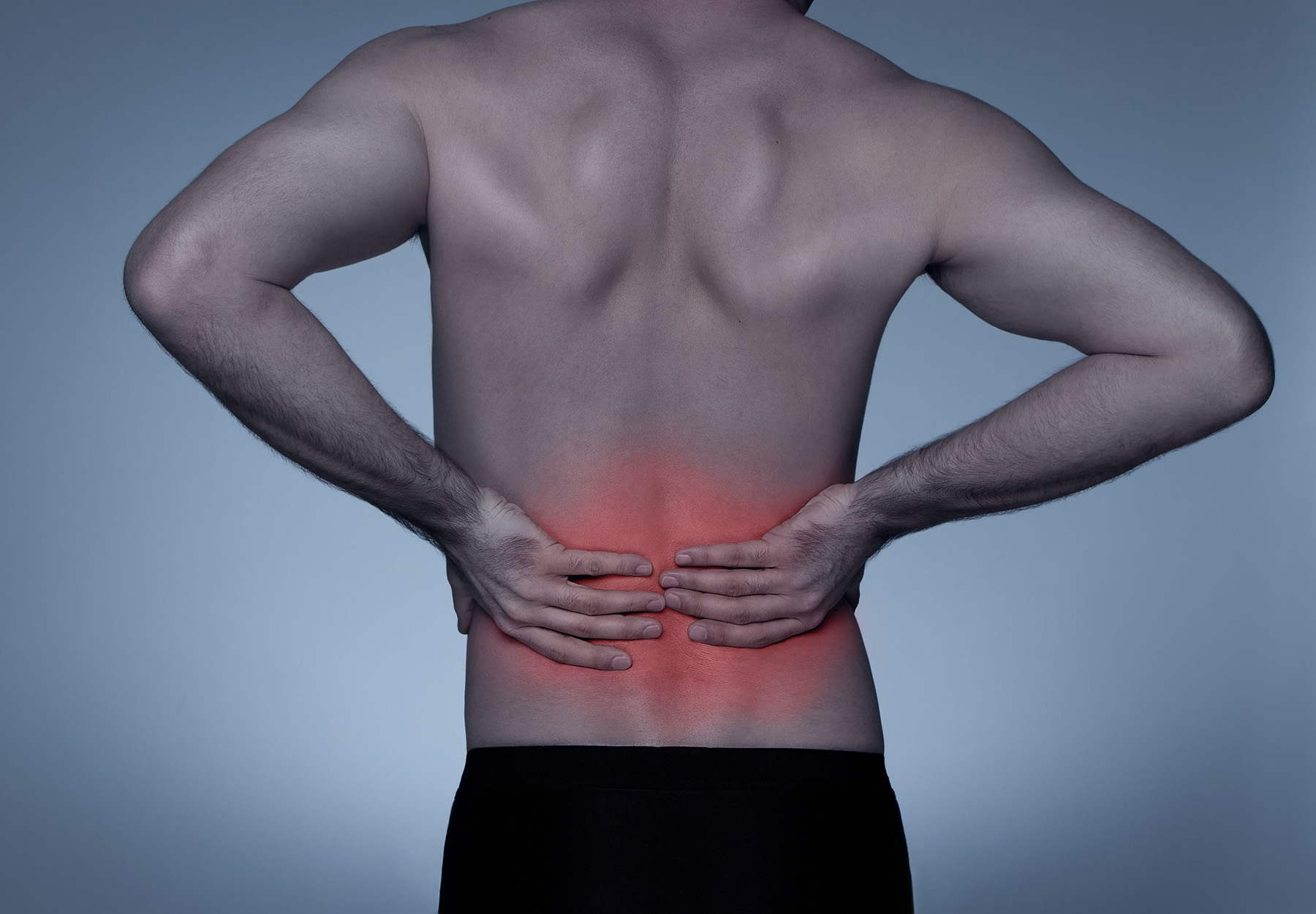 Person holding lower back due to back pain